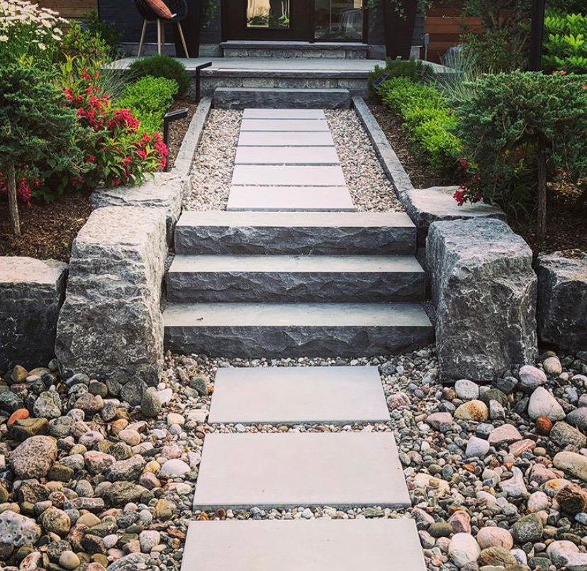 well kept garden with clean stone and pebble walkway