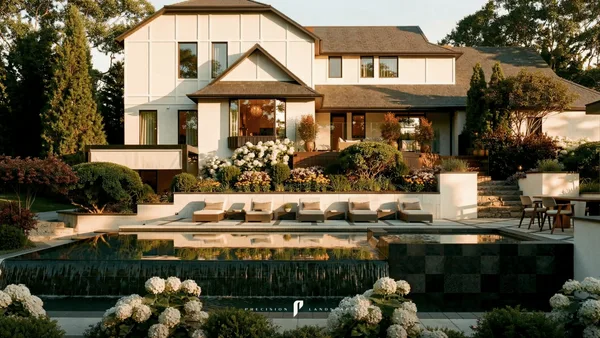 Brule infinity-edge pool below the house, framed by raised planter retaining walls and hydrangeas