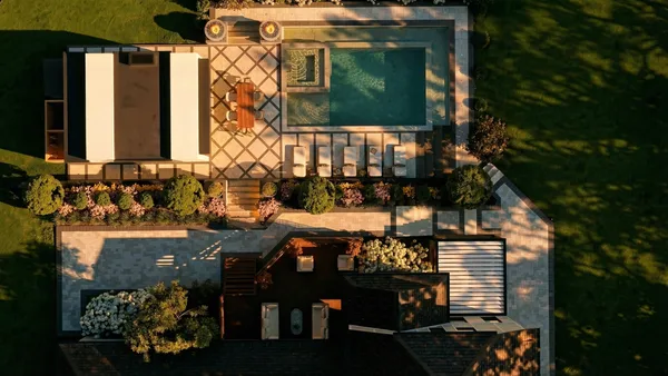 Brule landscape design render &mdash; Overhead aerial in afternoon light showing the pool, spa, cabana and the terraces stepping up to the house