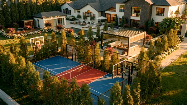 Multi-use sports court framed by cedars in the Meadow Wood backyard