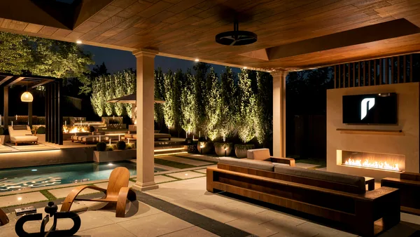 Dusk view from the covered lounge across the pool to the black steel pergola at Richard Serra Ct