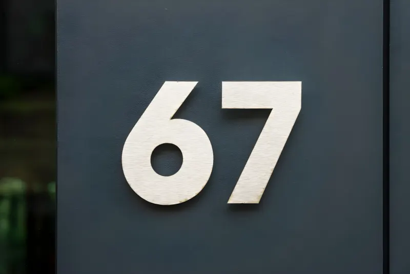 Modern house numbers on a dark exterior wall