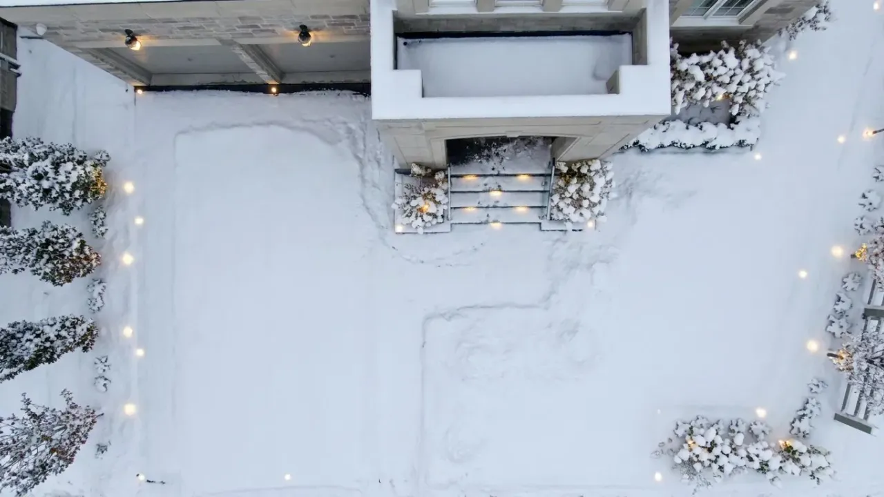 Same driveway fully covered in snow before the heating system runs