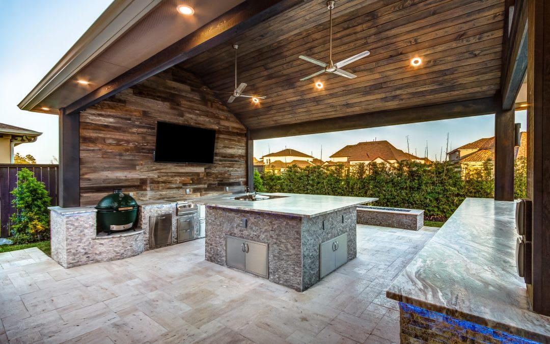 outdoor kitchen with angled roof and ceiling fans