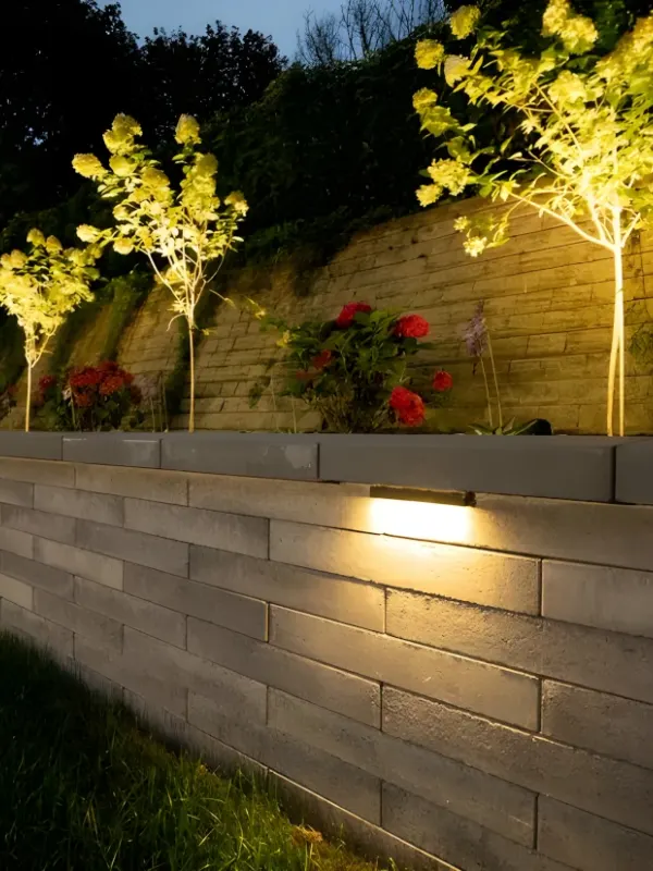 Retaining wall with landscape lighting