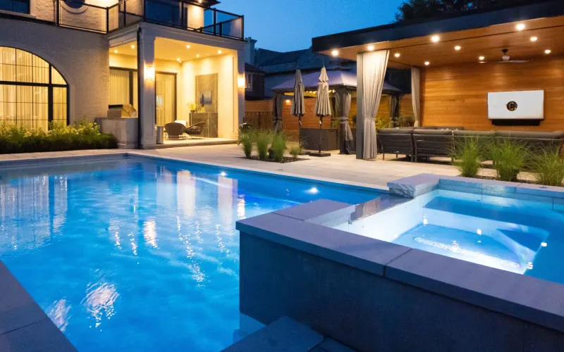 Custom concrete pool with an attached spa