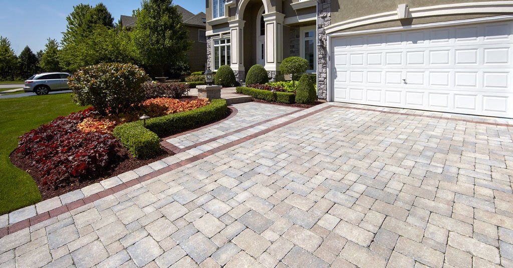 well trimmed shrubs and clean stone driveway