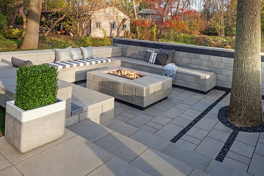 backyard stone firepit area with stone benches